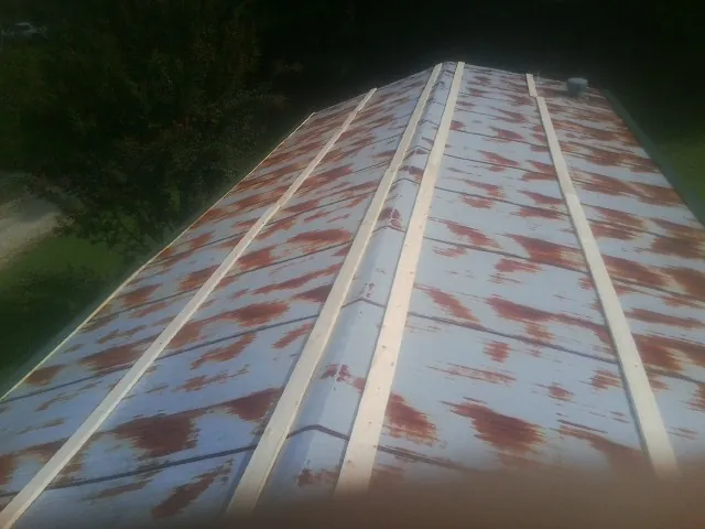 Rusted metal roof panels with new wood purlins before replacement — Storm Damage Roof Repair in Mobile by Roofing Brothers